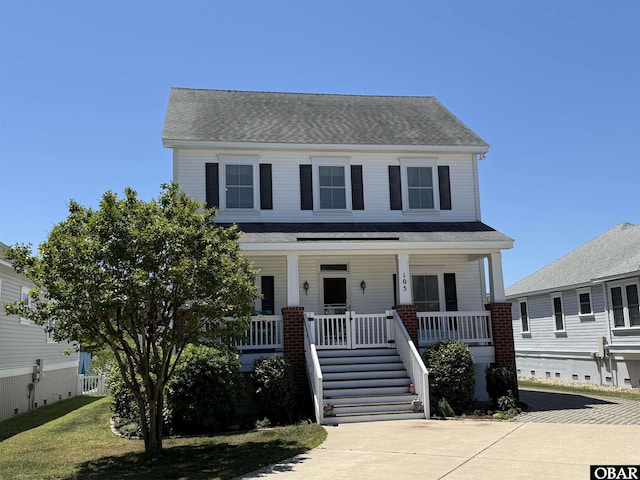 view of front of home featuring stairs, a shingled roof, and a porch