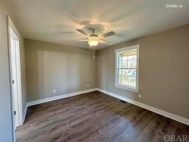 empty room with dark wood-style floors, visible vents, baseboards, and ceiling fan