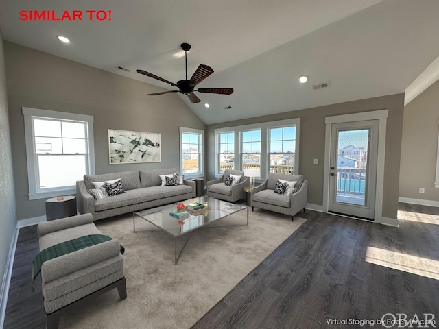 living room with lofted ceiling, a wealth of natural light, visible vents, and wood finished floors