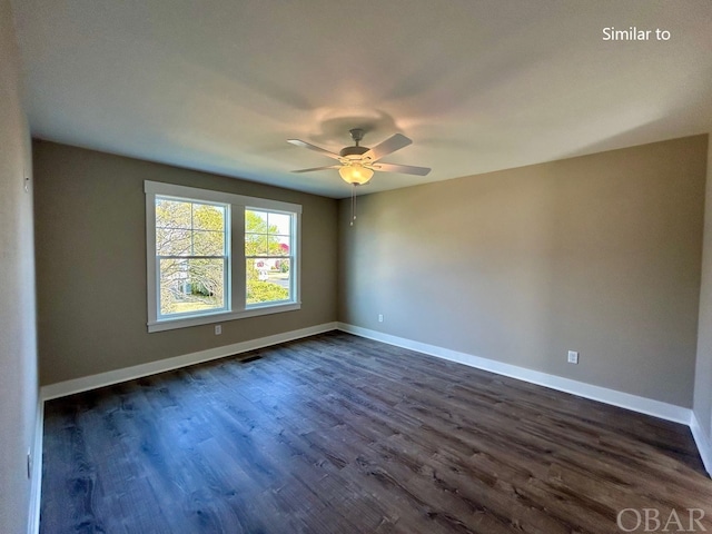 empty room featuring dark wood-style floors, visible vents, baseboards, and a ceiling fan