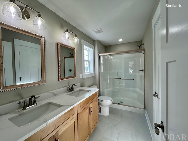 bathroom featuring a stall shower, marble finish floor, visible vents, and a sink