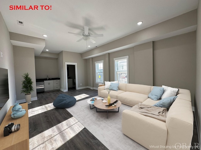 living room featuring wood finished floors, visible vents, and recessed lighting