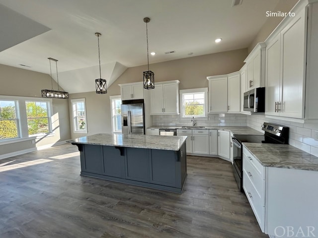 kitchen featuring appliances with stainless steel finishes, white cabinets, and a kitchen island