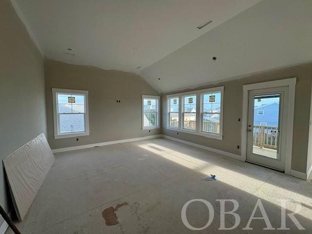 empty room with lofted ceiling and baseboards