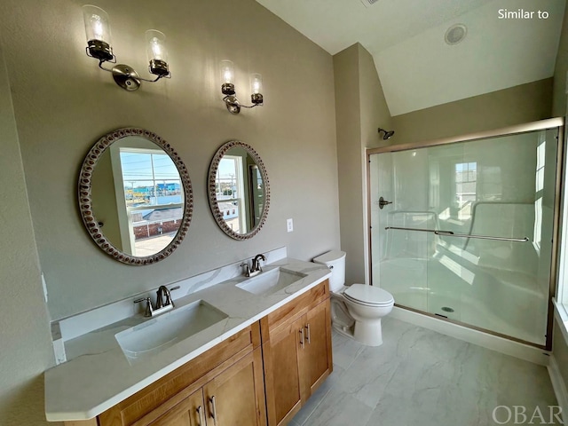 full bathroom with vaulted ceiling, a sink, marble finish floor, and a shower stall