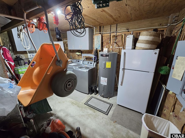 utility room with electric water heater and washer and dryer