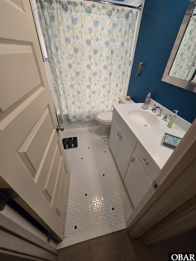 bathroom featuring vanity, shower / bath combo with shower curtain, tile patterned flooring, and toilet