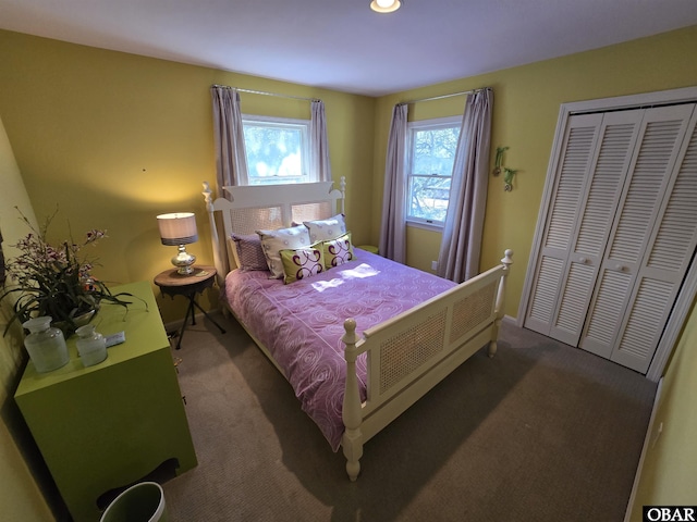 bedroom with a closet, baseboards, and carpet flooring