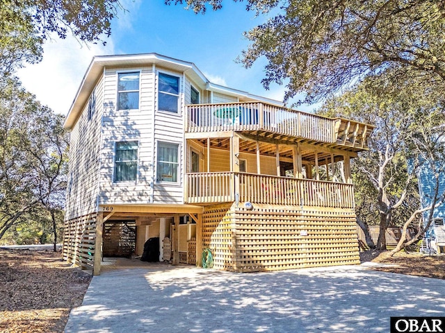 view of front of home featuring driveway and a deck