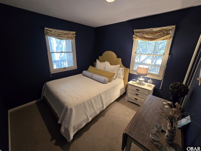 bedroom featuring carpet floors and baseboards