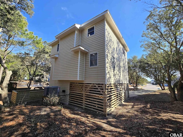 rear view of property featuring central air condition unit