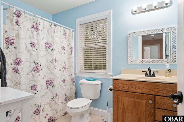 bathroom with baseboards, a shower with shower curtain, toilet, vanity, and tile patterned flooring