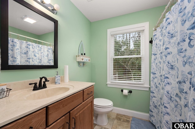 bathroom with a shower with shower curtain, vanity, baseboards, and toilet