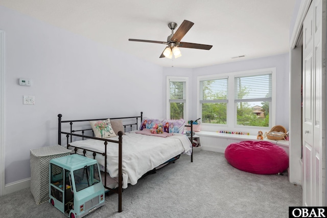 bedroom with a closet, visible vents, and carpet