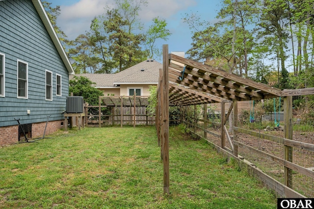 view of yard featuring central AC unit and fence