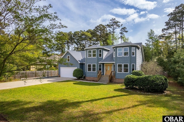 shingle-style home featuring a front lawn, fence, a garage, and driveway
