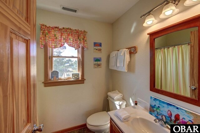 183 Lighthouse Rd Lot 3, Ocracoke, NC 27960 - bathroom featuring baseboards, visible vents, vanity, and toilet