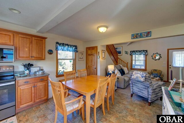183 Lighthouse Rd Lot 3, Ocracoke, NC 27960 - dining space featuring stairway, plenty of natural light, stone finish floor, and beam ceiling