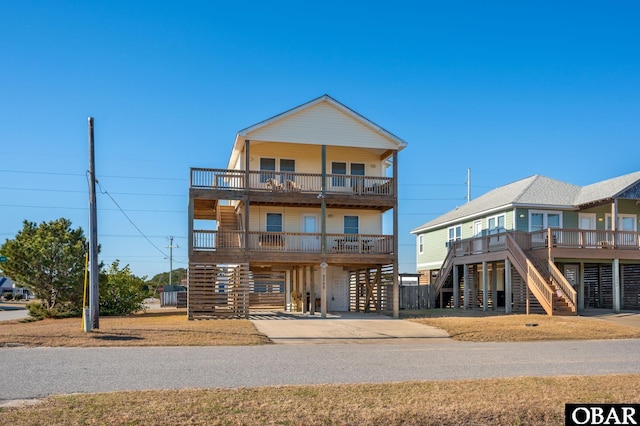 coastal home featuring a carport and concrete driveway