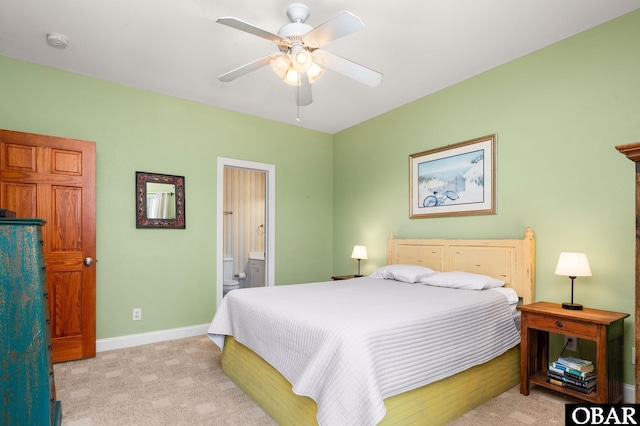 25238 Mac Oca Dr Lot 14, Waves, NC 27982 - bedroom with light carpet, baseboards, connected bathroom, and ceiling fan