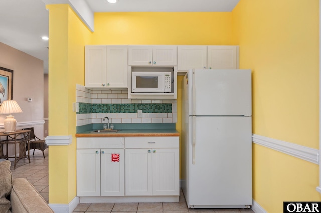25238 Mac Oca Dr Lot 14, Waves, NC 27982 - kitchen with white appliances, a sink, backsplash, white cabinets, and light tile patterned flooring