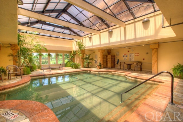 community pool with glass enclosure and a patio