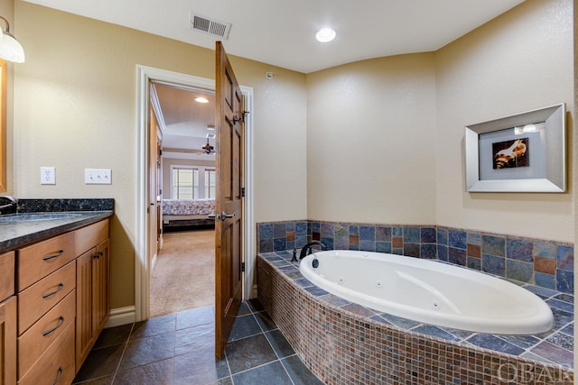 full bath featuring vanity, visible vents, tile patterned floors, a tub with jets, and ensuite bath