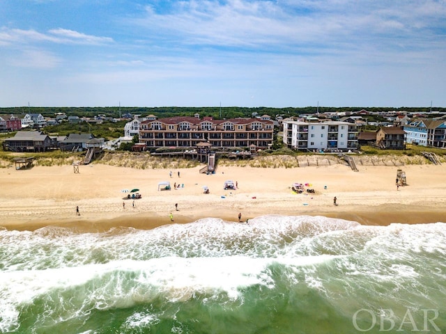 bird's eye view featuring a water view and a beach view