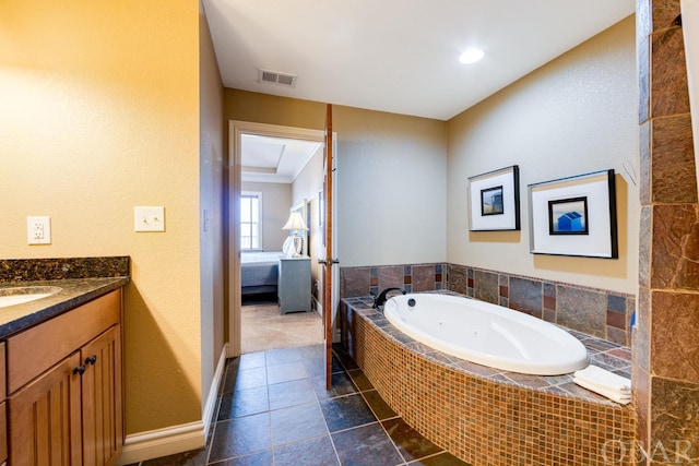 ensuite bathroom with ensuite bathroom, tile patterned flooring, vanity, visible vents, and a bath