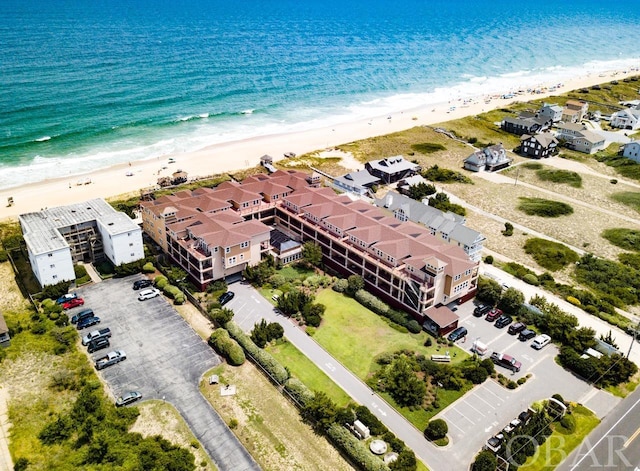 birds eye view of property with a water view and a view of the beach