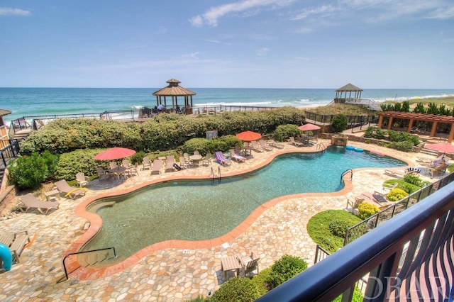 pool featuring a gazebo and a water view