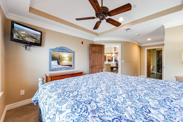 bedroom with ornamental molding, a tray ceiling, visible vents, and baseboards