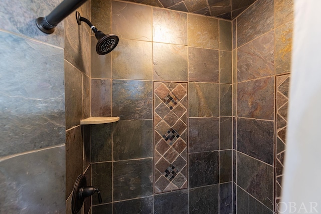 bathroom with a tile shower