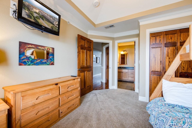 bedroom with ensuite bathroom, visible vents, baseboards, carpet, and crown molding