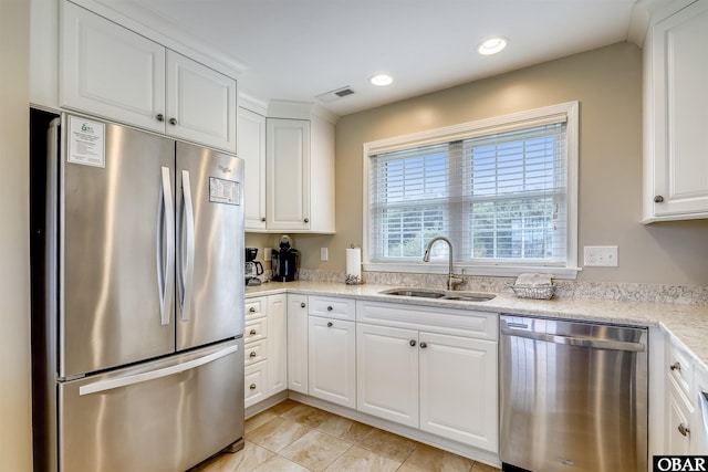 133 Ships Watch Dr Lot # 33, Duck, NC 27949 - kitchen with appliances with stainless steel finishes, a sink, white cabinets, light tile patterned flooring, and recessed lighting