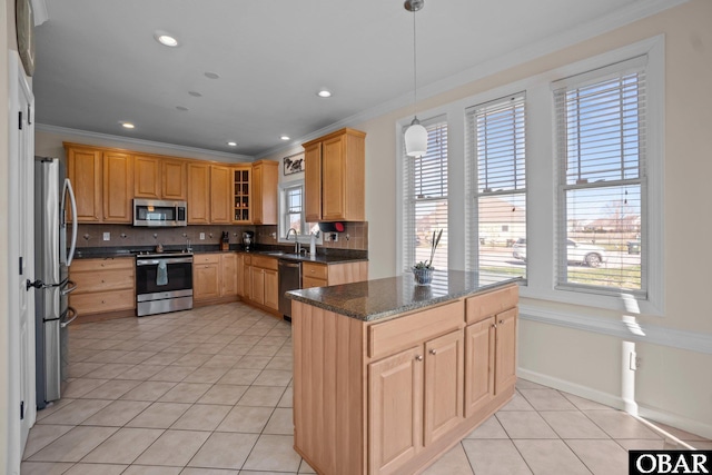 kitchen with light tile patterned floors, decorative backsplash, appliances with stainless steel finishes, ornamental molding, and a sink