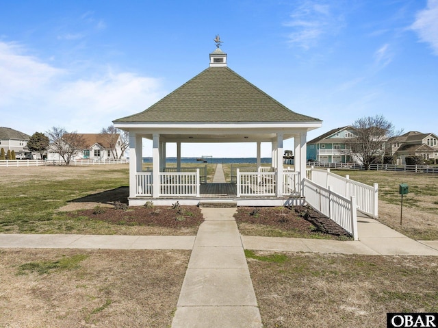 view of home's community featuring a gazebo, a lawn, and fence