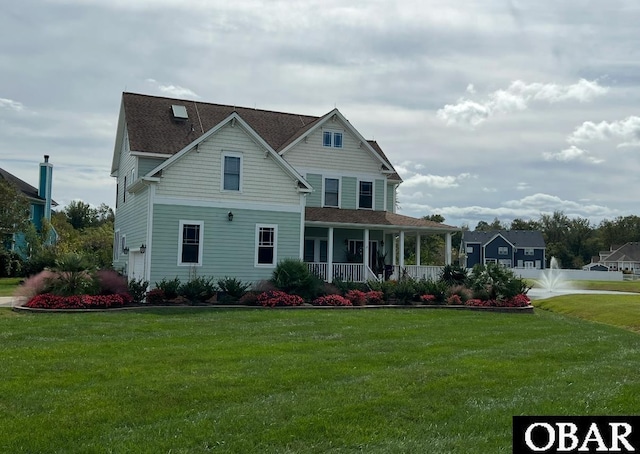 view of front of property with covered porch and a front lawn