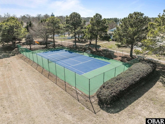 view of tennis court featuring fence