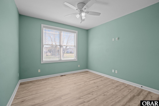 unfurnished room with light wood finished floors, ceiling fan, and baseboards