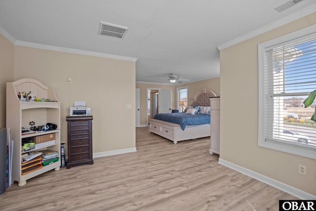 bedroom featuring baseboards, visible vents, crown molding, and light wood finished floors