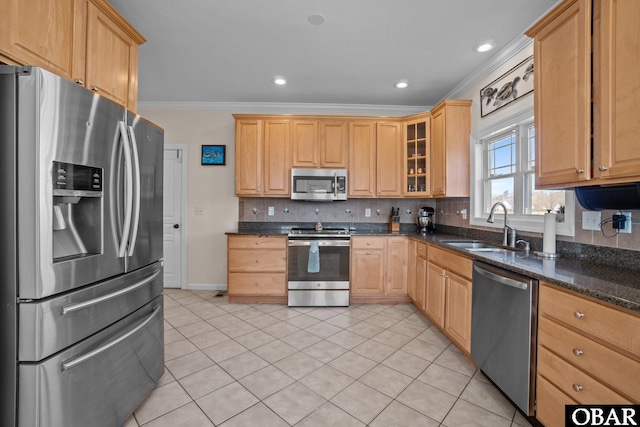 kitchen featuring glass insert cabinets, ornamental molding, a sink, stainless steel appliances, and backsplash