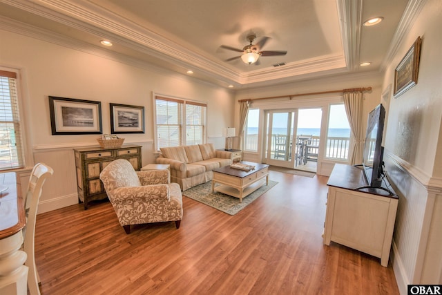24252 Resort Rodanthe Dr Unit 1C, Rodanthe, NC 27968 - living room with ceiling fan, light wood finished floors, a wainscoted wall, ornamental molding, and a raised ceiling