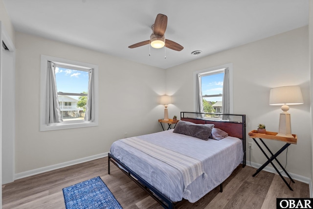 402 N Memorial Blvd Lot 3, Kill Devil Hills, NC 27948 - bedroom featuring multiple windows, wood finished floors, and baseboards