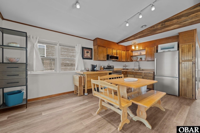 402 N Memorial Blvd Lot 3, Kill Devil Hills, NC 27948 - dining space with vaulted ceiling, rail lighting, light wood finished floors, and baseboards