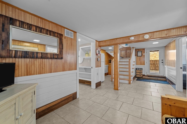 402 N Memorial Blvd Lot 3, Kill Devil Hills, NC 27948 - entrance foyer with wood walls, stairway, and light tile patterned flooring