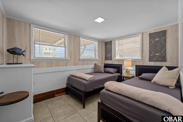 402 N Memorial Blvd Lot 3, Kill Devil Hills, NC 27948 - bedroom with light tile patterned flooring, wooden walls, ornamental molding, and baseboards