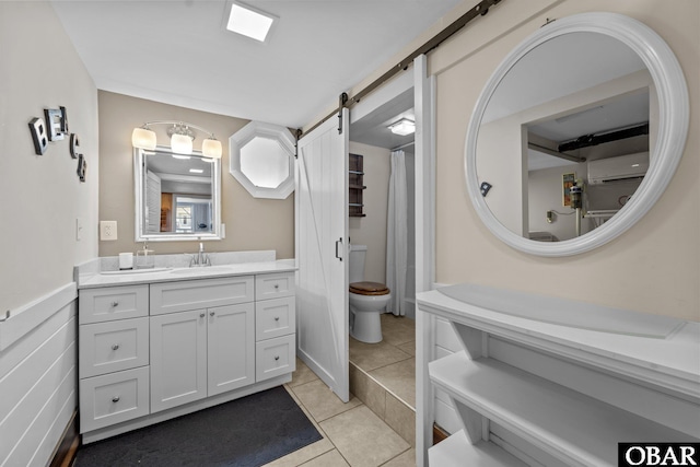 402 N Memorial Blvd Lot 3, Kill Devil Hills, NC 27948 - bathroom with a wall mounted air conditioner, vanity, tile patterned flooring, and toilet
