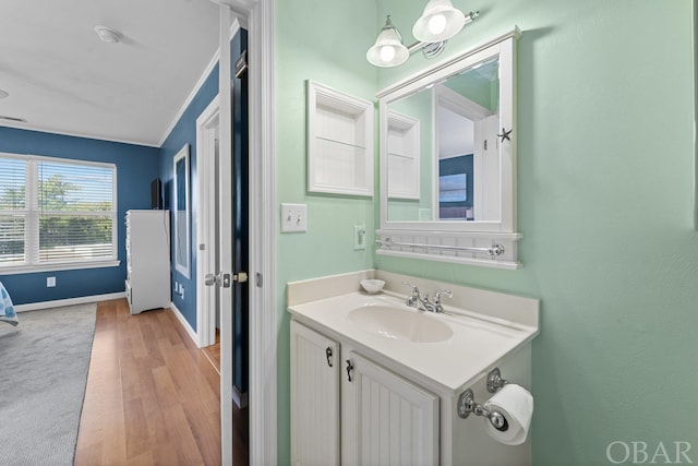 bathroom featuring wood finished floors, vanity, and baseboards