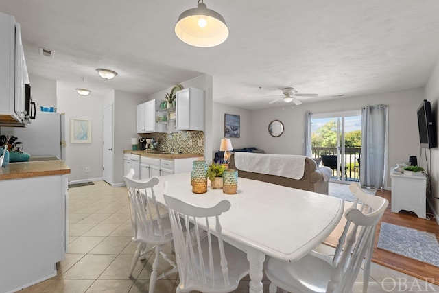 dining area featuring visible vents, ceiling fan, baseboards, and light tile patterned floors